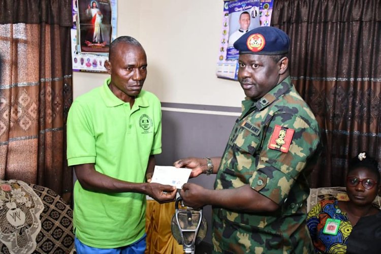NYSC DG Hands Over cheque to Mr Omale Samuel parents of Missing Corps Member