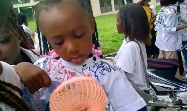 Daughter of Late JOSTUM Student Wears Mother's Image on Shirt as Classmates Sign Out in Her Memory