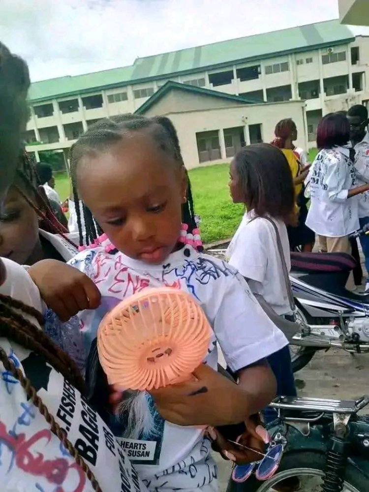 Daughter of Late JOSTUM Student Wears Mother's Image on Shirt as Classmates Sign Out in Her Memory